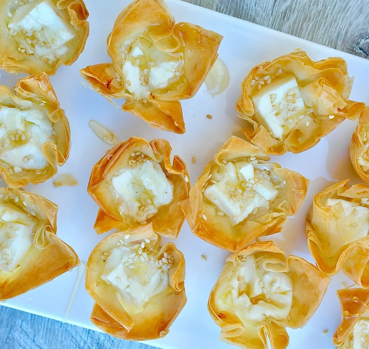 https://www.olivetomato.com/wp-content/uploads/2023/12/Baked-Feta-Honey-Bites-easy-phyllo-appetizer-3.webp